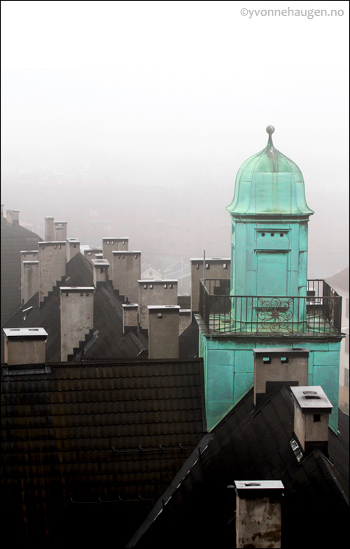 Fog around the green roof top tower 